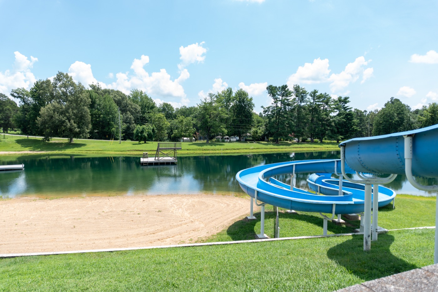 Sandy beach, swim platforms, and waterslide